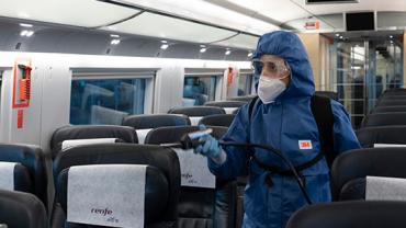 Imatge d'una treballadora desinfectant un tren.