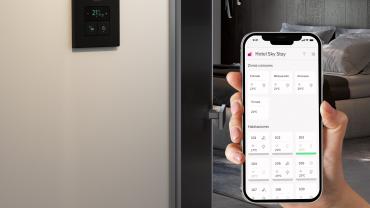 Imatge d'un dispositiu mòbil d'smart building en una habitació d'hotel
